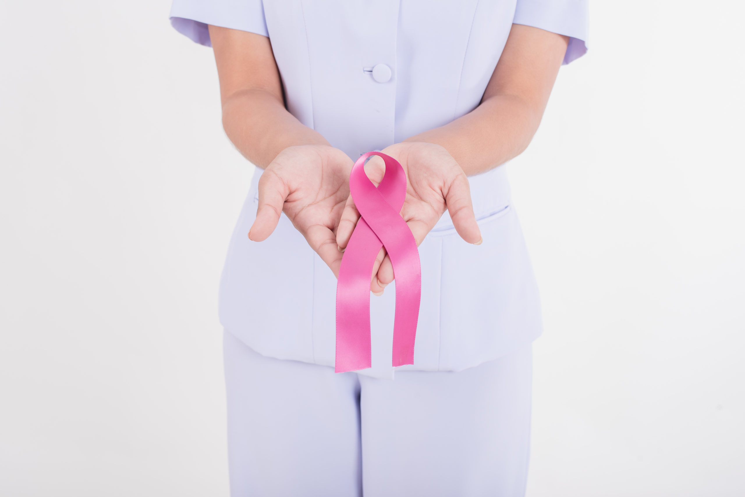 Asian nurse with pink ribbon. Pink ribbon is an international symbol of breast cancer awareness.Medicine and healthcare concept